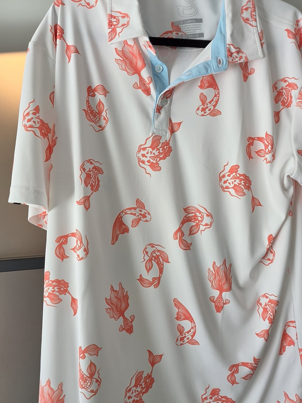 Men's White Polo Shirt with Coral Fish Print- Indian Wells Golf Resort Logo